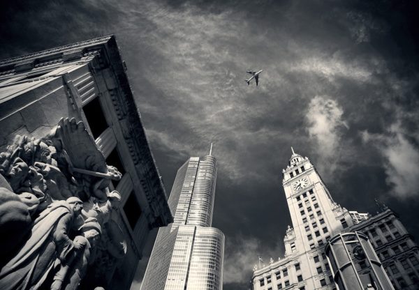 Michigan Avenue looking up at airplane flying over