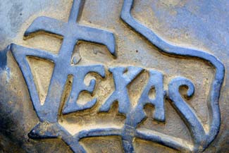 Metal engraved sign saying "Texas," image is in full colour.